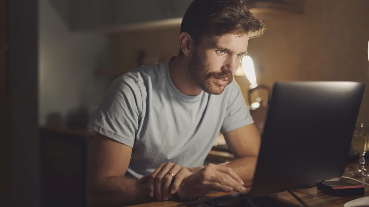 Remote work from home, computer and man with online reading, night and connection. Copywriting, person and freelancer with pc, research for article and editor with proposal and website information