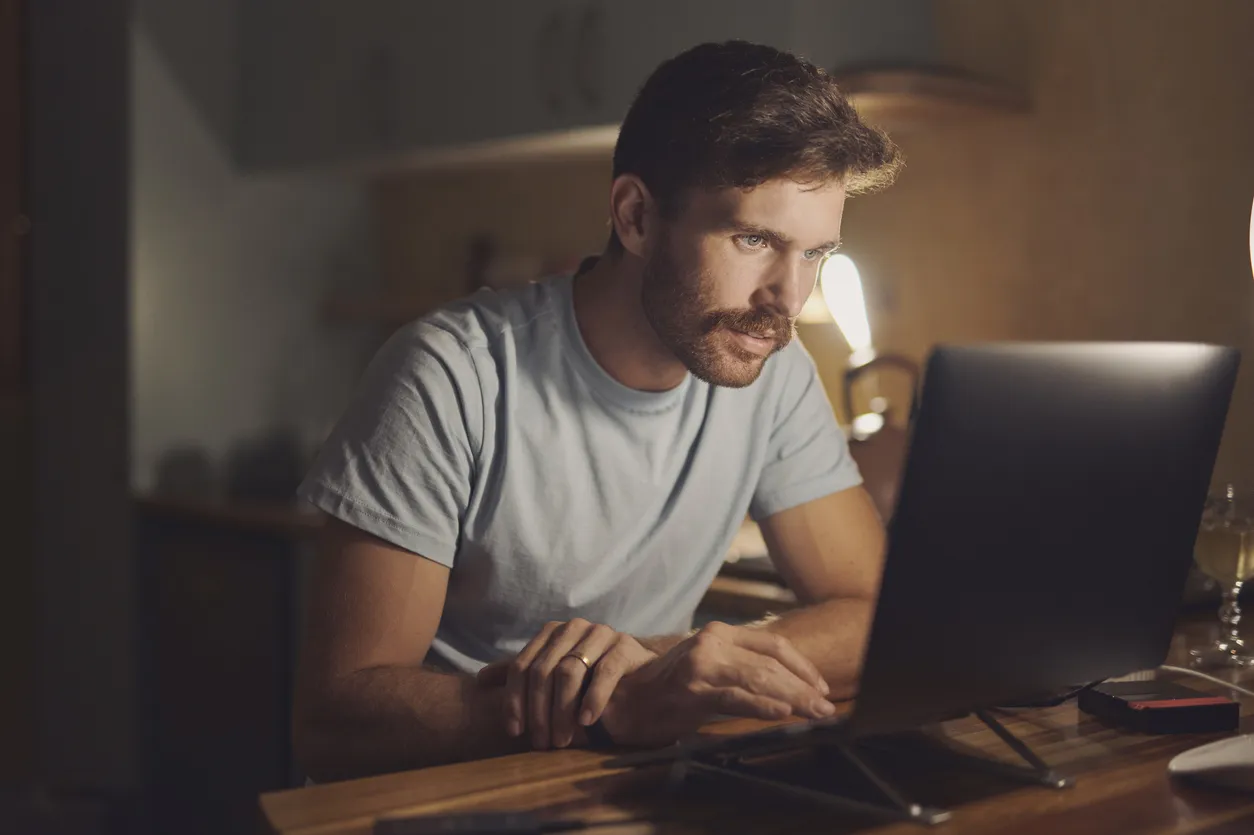 Remote work from home, computer and man with online reading, night and connection. Copywriting, person and freelancer with pc, research for article and editor with proposal and website information